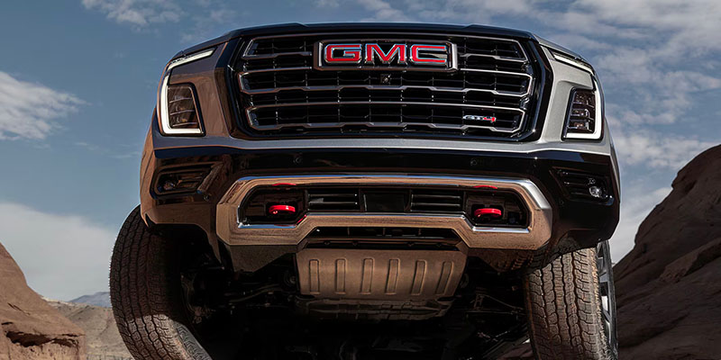 The commanding presence of the 2025 GMC Yukon as shown from an up angle on its front grille in Bryant, AR 