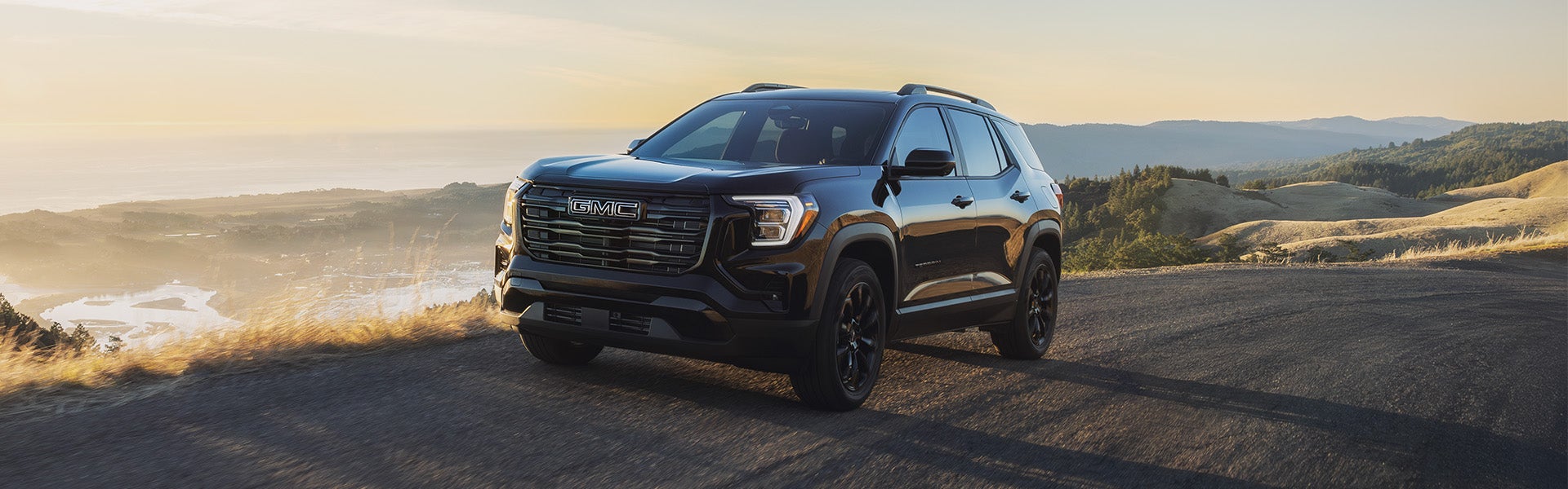 2027 GMC Terrain dashboard with 15-inch infotainment touchscreen, digital driver display, and partial steering wheel view in Bryant, AR.